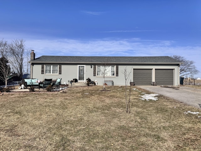 ranch-style home with a garage and a front yard