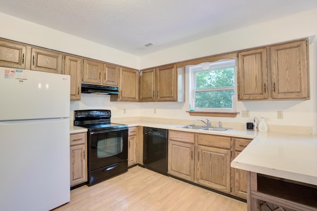 kitchen with a textured ceiling, sink, light hardwood / wood-style flooring, and black appliances