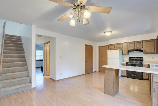 kitchen featuring white fridge, light hardwood / wood-style flooring, a textured ceiling, and black range with electric cooktop