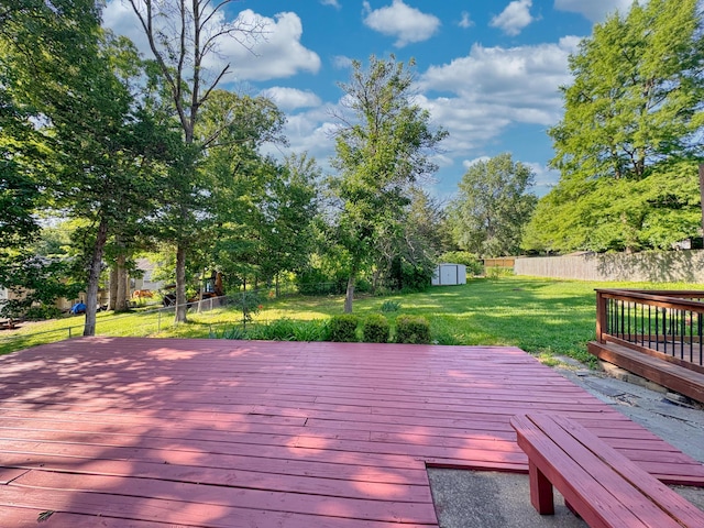 deck with a yard and a storage unit