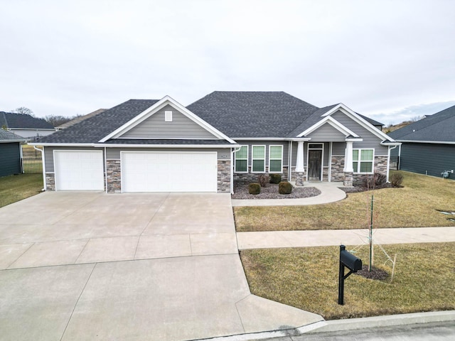 craftsman inspired home with a garage and a front yard