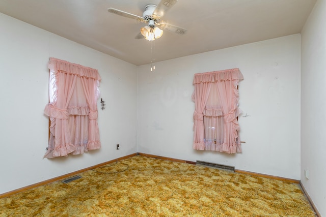 carpeted spare room with ceiling fan