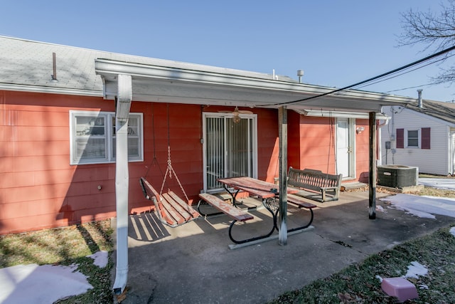 back of property with cooling unit and a patio area