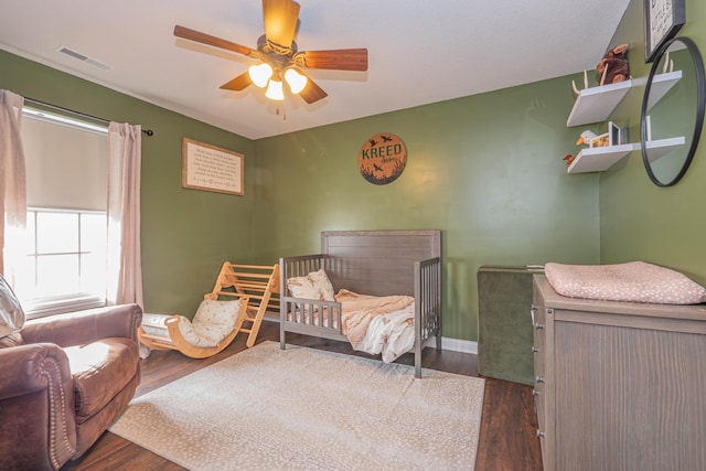 bedroom with ceiling fan and dark hardwood / wood-style flooring