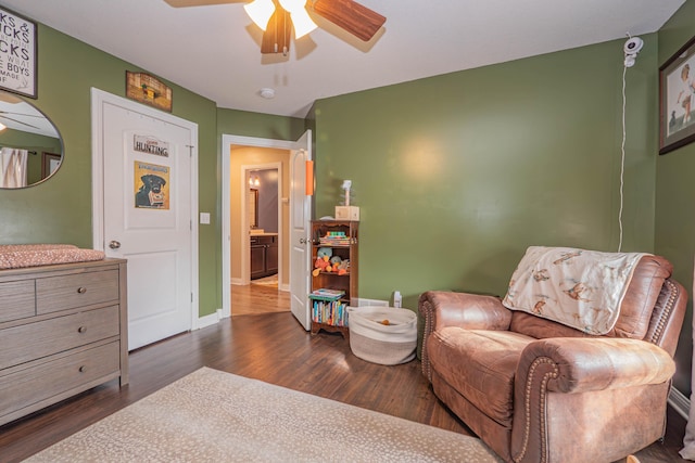 living area featuring ceiling fan and dark hardwood / wood-style floors