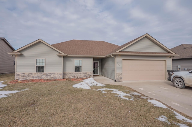 ranch-style home featuring a garage and a front lawn