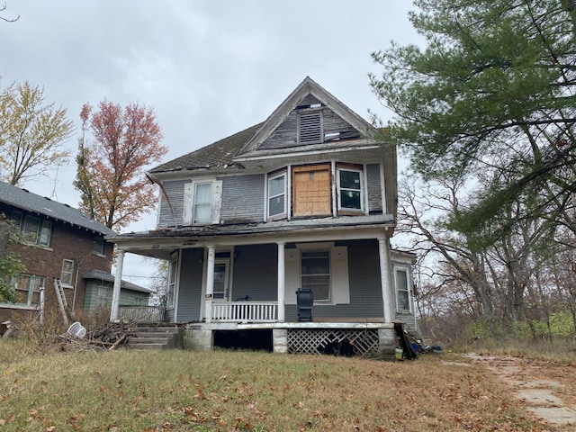 victorian house featuring a front yard and covered porch