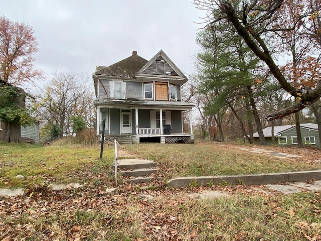 victorian-style house featuring a porch