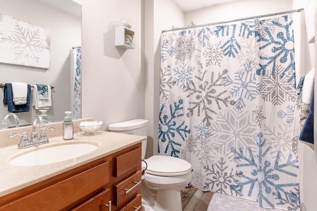 bathroom featuring a shower with curtain, vanity, and toilet