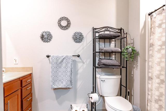 bathroom with vanity, toilet, and a shower with shower curtain