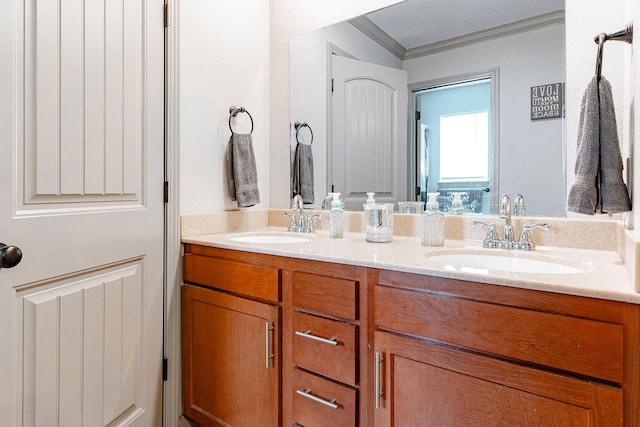 bathroom featuring crown molding and vanity