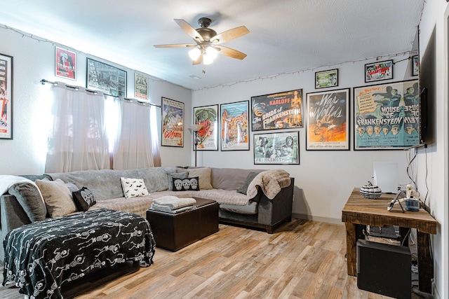 living room with ceiling fan and light wood-type flooring