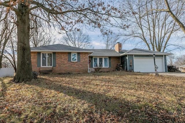 ranch-style house with a garage and a front lawn