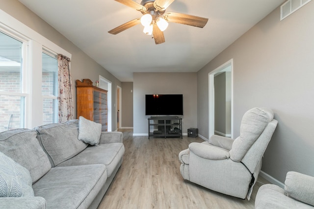 living room featuring ceiling fan and light wood-type flooring