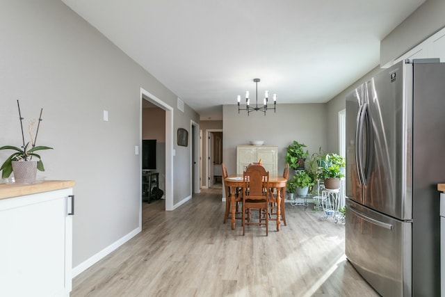 dining area featuring a chandelier and light hardwood / wood-style floors