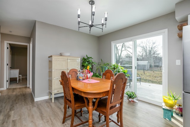 dining area with a chandelier and light hardwood / wood-style floors