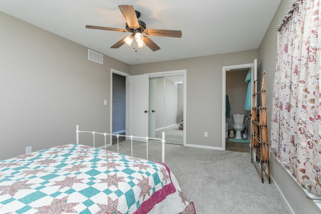 carpeted bedroom with ensuite bath, a closet, and ceiling fan