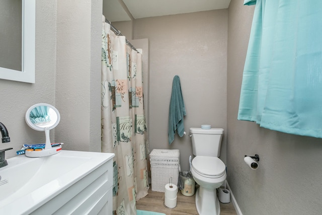 bathroom with vanity, hardwood / wood-style floors, and toilet