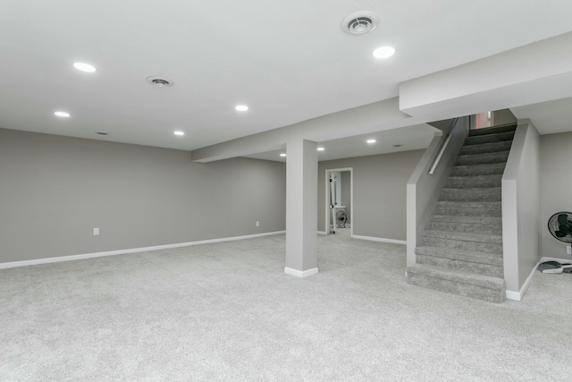 basement featuring light colored carpet