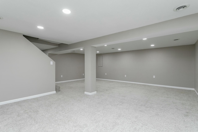 basement featuring light carpet