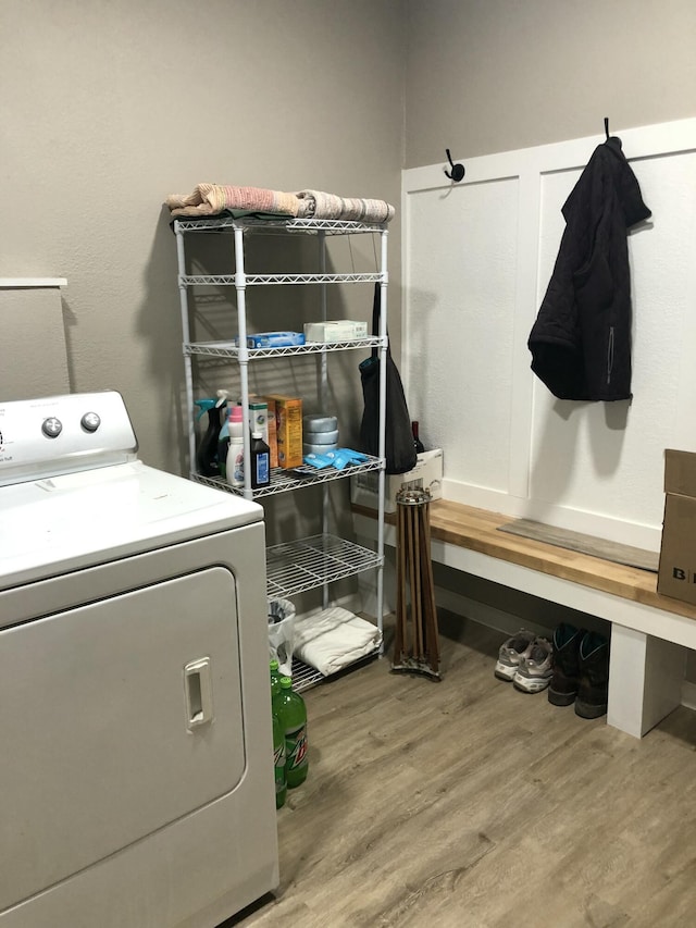 laundry room featuring wood-type flooring and washer / dryer