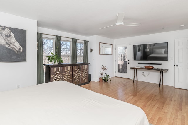 bedroom featuring access to exterior, wood-type flooring, and ceiling fan