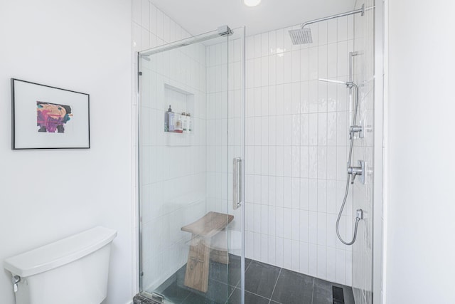 bathroom with an enclosed shower and toilet