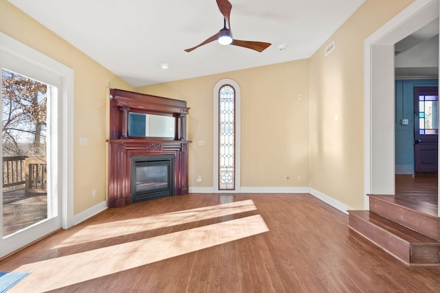 unfurnished living room featuring hardwood / wood-style flooring, ceiling fan, and lofted ceiling