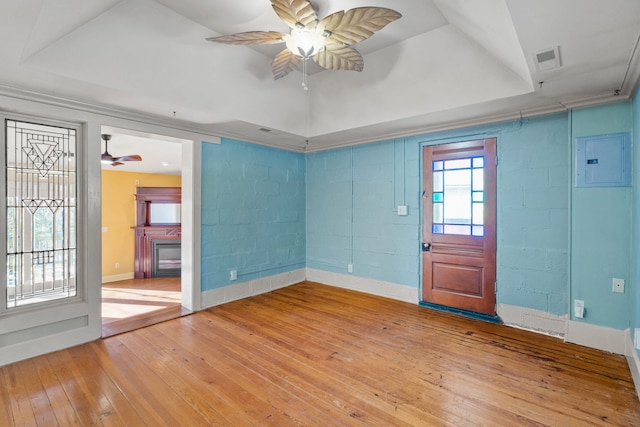 interior space featuring a fireplace, wood-type flooring, lofted ceiling, electric panel, and ceiling fan