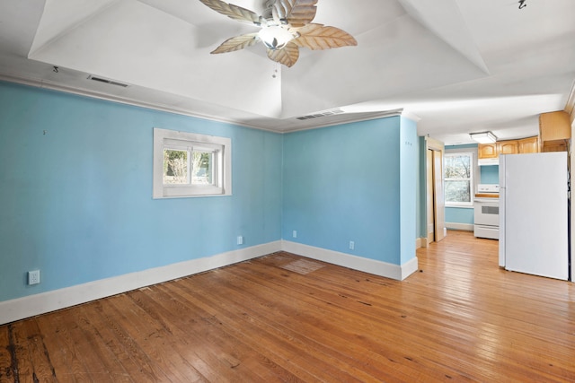 spare room featuring ceiling fan, plenty of natural light, and light wood-type flooring