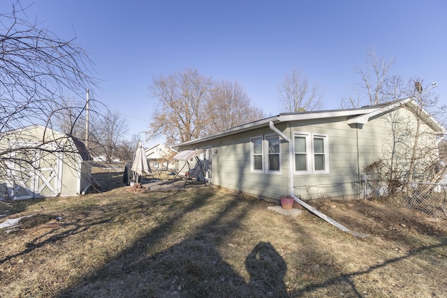 view of home's exterior featuring a storage unit