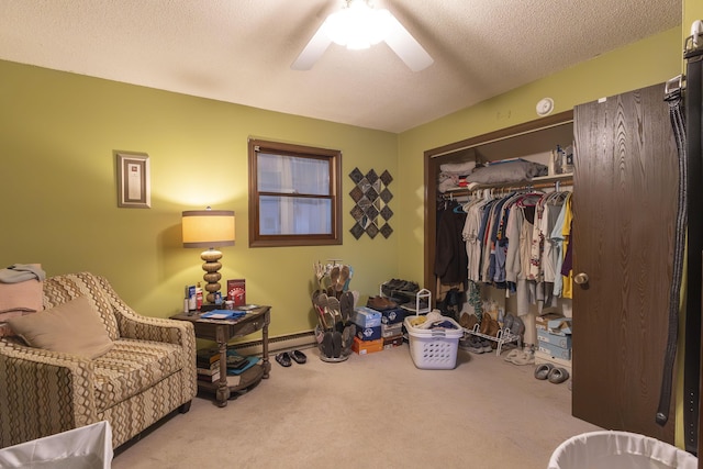 sitting room featuring light carpet, ceiling fan, and a textured ceiling