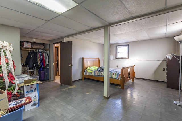 bedroom with a drop ceiling and a closet