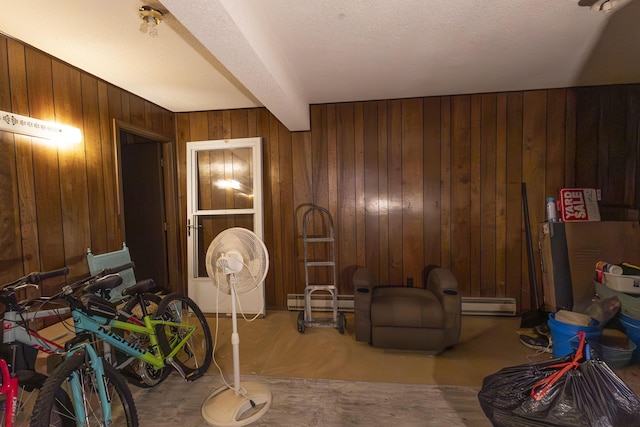 sitting room featuring wooden walls and beamed ceiling