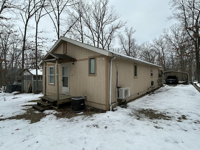 view of snowy exterior with central air condition unit