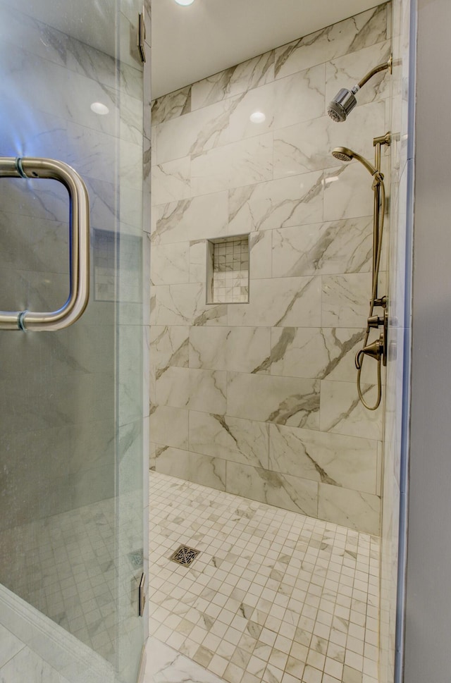 bathroom with a shower with door