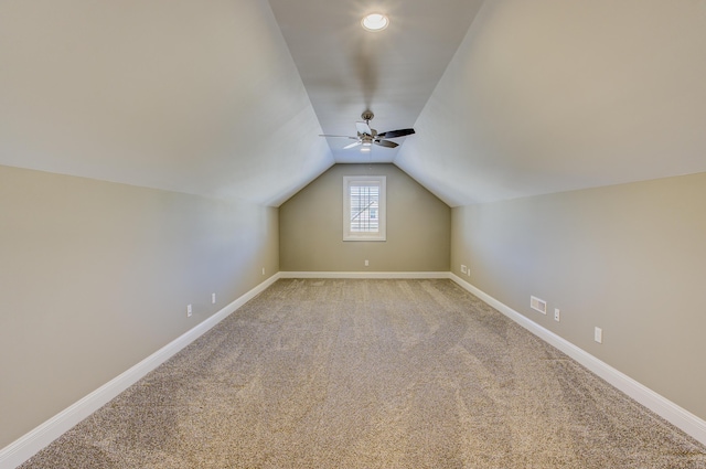 bonus room with ceiling fan, lofted ceiling, and light carpet