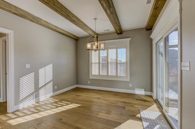 unfurnished dining area with beam ceiling, a chandelier, and light wood-type flooring