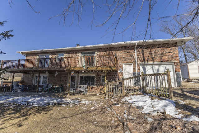 snow covered property featuring a patio area and a deck