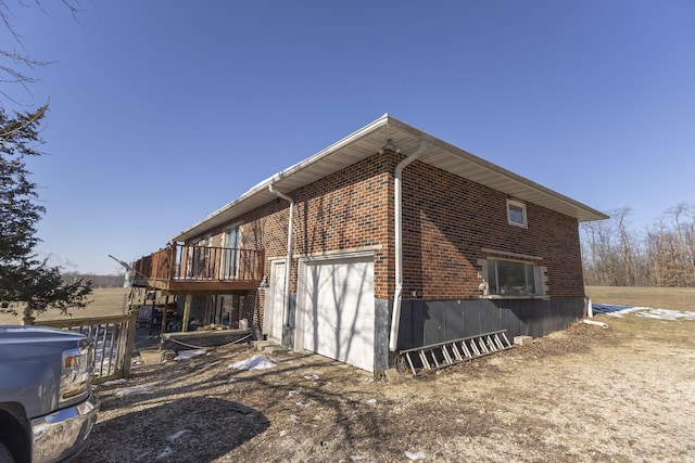 view of side of property featuring a garage and a deck