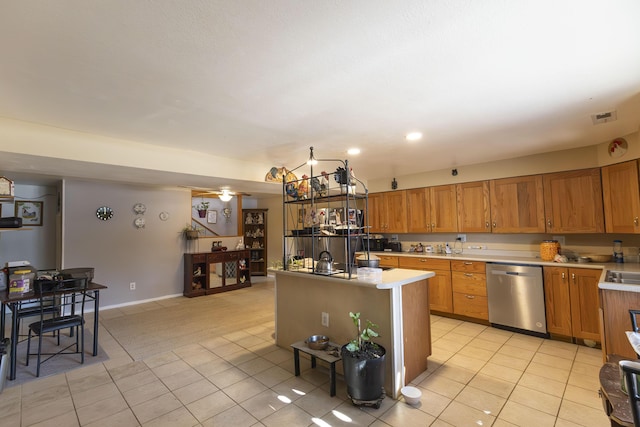 kitchen with dishwasher, a kitchen island with sink, and light tile patterned flooring