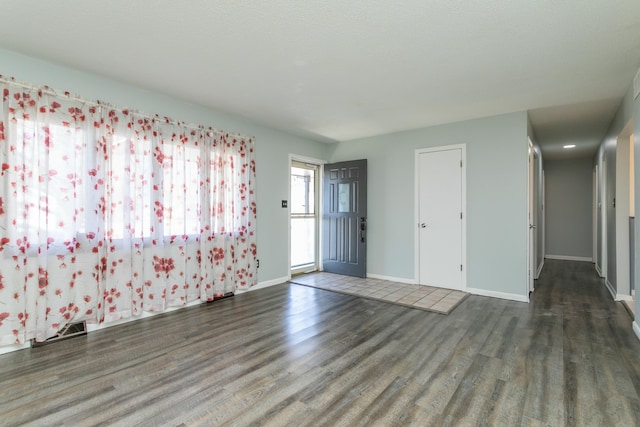 unfurnished room with dark hardwood / wood-style floors