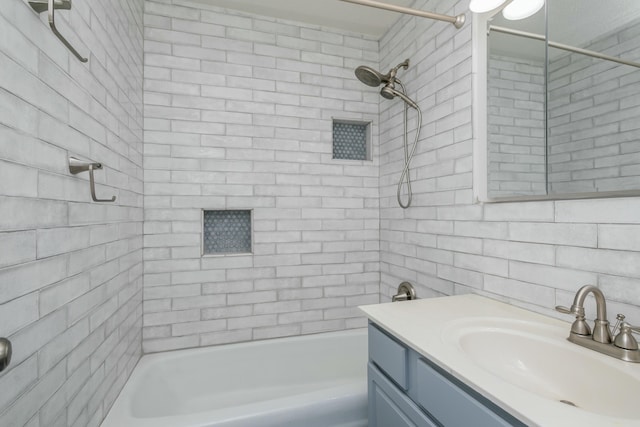 bathroom featuring vanity and tiled shower / bath