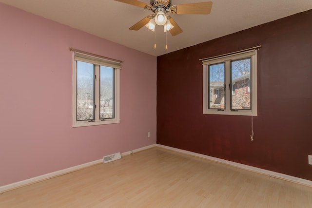 empty room with light hardwood / wood-style floors and ceiling fan