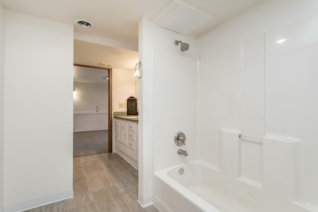 bathroom featuring vanity,  shower combination, and hardwood / wood-style floors