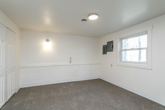 carpeted spare room featuring electric panel