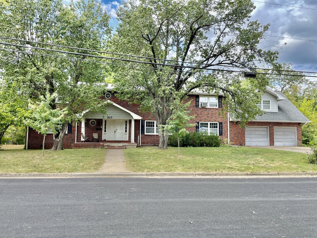 view of front of home with a garage and a front yard