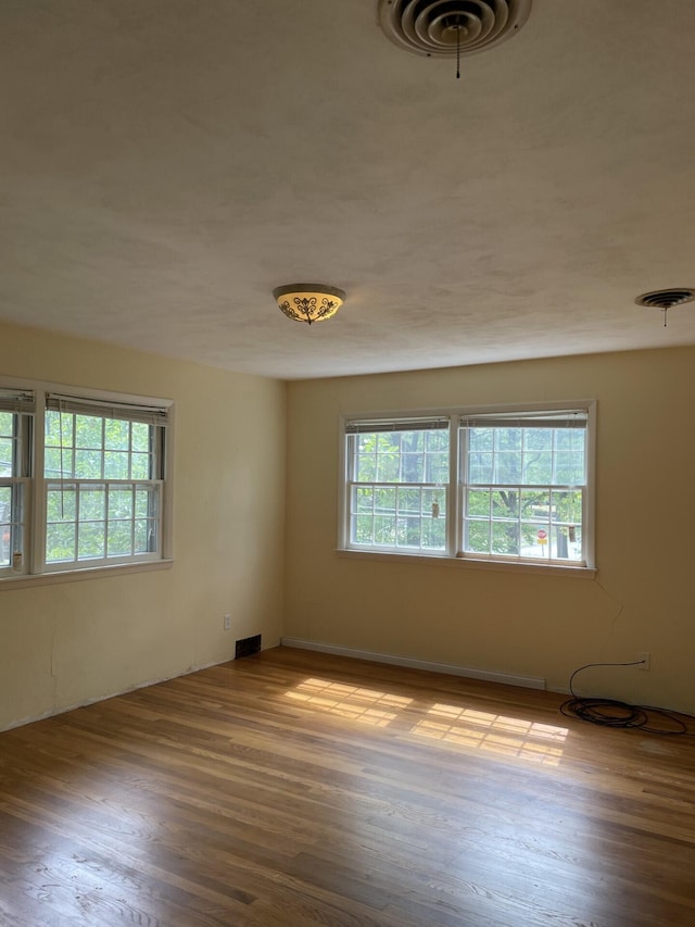 unfurnished room with light hardwood / wood-style floors