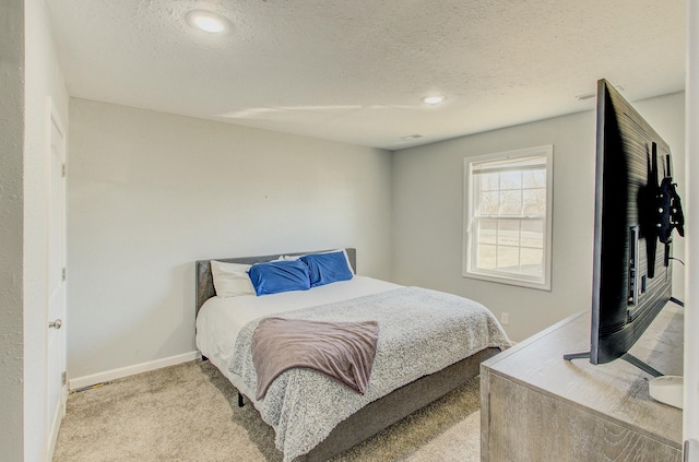 carpeted bedroom featuring a textured ceiling