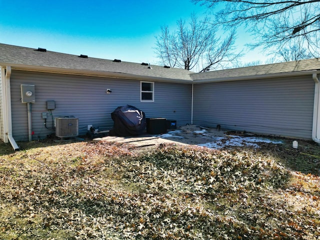 rear view of house featuring cooling unit